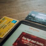 Credit cards beside a tablet on a desk